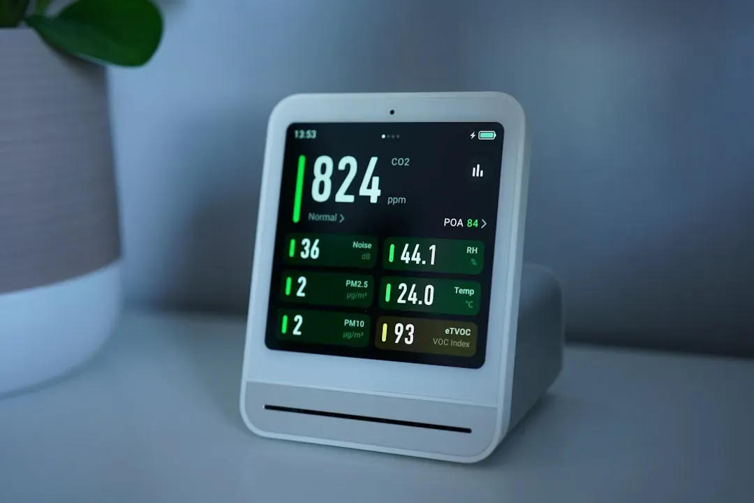 Air quality monitor displaying PM2.5, CO2, humidity, and temperature readings for home air quality monitoring system setup