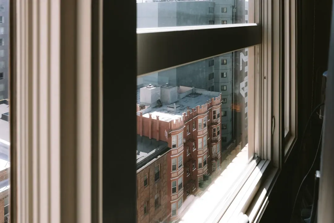 Person opening windows in bright rental apartment to improve air quality through natural ventilation and cross-airflow