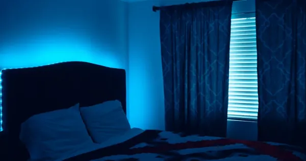 Modern bedroom air purifier on nightstand with sleeping person, demonstrating quiet effective air purification for restful sl